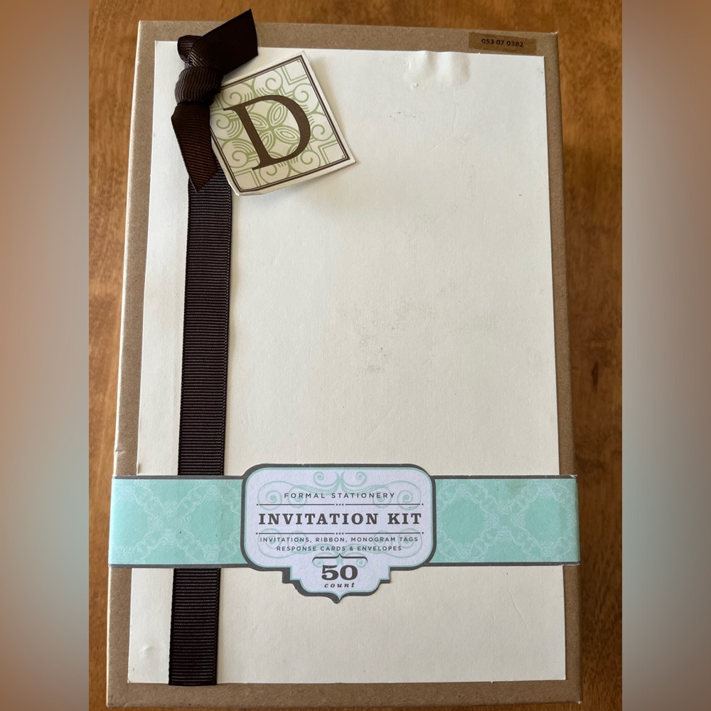 Formal invitation kit. Cream stationery / brown ribbon & monogram tags. 50 sets.
